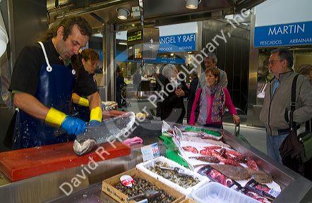 Seafood vendor at the Mercado de al Ribera along the Nervion River at Bilbao, Biscay, Spain.