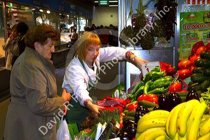 Produce vendor at the Mercado de al Ribera along the Nervion River at Bilbao, Biscay, Spain.