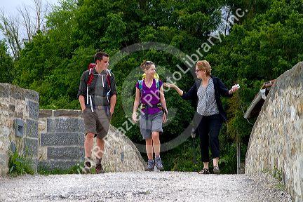 Modern day pilgrims walk along the Camino De Santiago, the Way of St. James pilgrimage route, Navarra, Spain.
