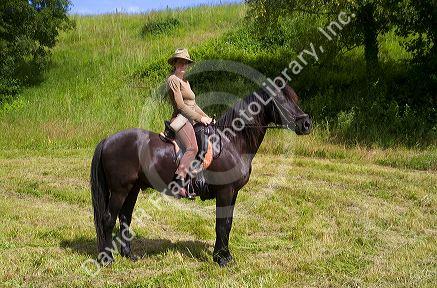 French woman riding her horse on a farm near Angouleme in southwestern France.