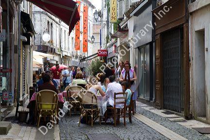 People sit at an outdoor cafe at Angouleme in southwestern France.