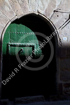 Arched door at Puente La Reina a Basque town along the Way of St. James pilgrimage route, Navarra, Spain.