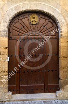 Arched door at Puente La Reina a Basque town along the Way of St. James pilgrimage route, Navarra, Spain.