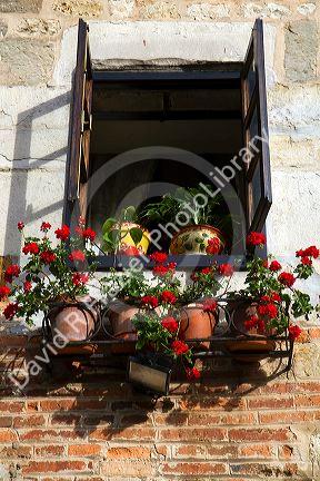 Flower pots in the window of a building in the village of Santillana del Mar, Cantabria, Spain.