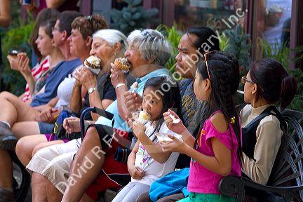 Tourists eat ice cream at Waterton Park townsite in Waterton Lakes National Park, Alberta, Canada.