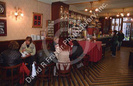 People drink coffee in an Italian cafe.