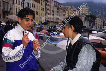 Teens hanging out talking in Italy.
