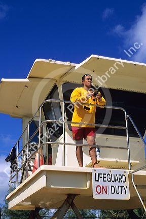 A lifeguard with binoculars in Kauai, Hawaii.  MR