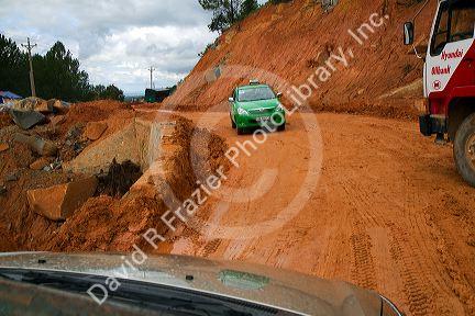 Road made of red clay at a construction site near Da Lat, Vietnam.