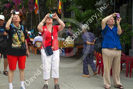 Russian tourists using cameras in Nha Trang, Vietnam.