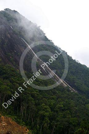 Tropical plant life and waterfall along the rural road between Da Lat and Nha Trang, Vietnam.