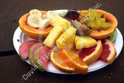 A fruit plate in Hawaii. Pappaya, fig, orange, pineapple, banana, guava, star fruit, lime, grapefruit.