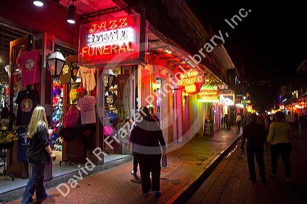 Business on Bourbon Street at night in the French Quarter, New Orleans, Louisiana, USA.