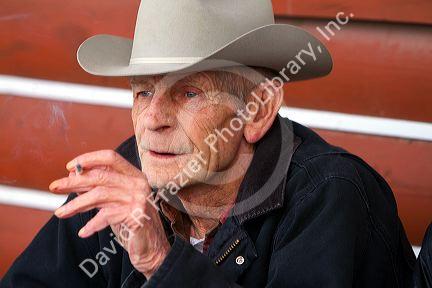 Old farmer smoking a cigarette outside a cafe in eastern Idaho, USA.