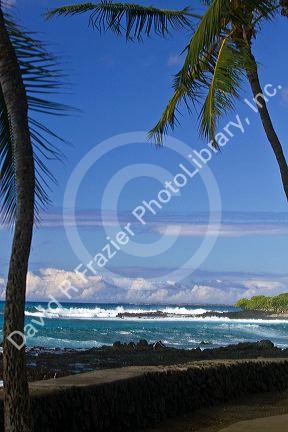 Waves crash along the rocky coast at Kailua-Kona on the Big Island of Hawaii, USA.