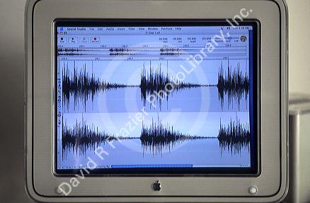 Sound engineer examines a spectrogram on a computer screen.