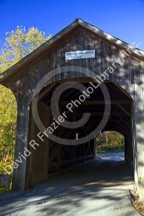 The Mill Covered Bridge crossing the Lamoille River in Belvidere, Vermont, USA.