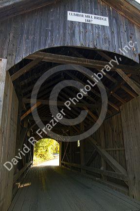 The Mill Covered Bridge crossing the Lamoille River in Belvidere, Vermont, USA.