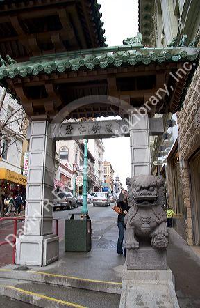 Stone figure of a dragon sits at the entrance to Chinatown, San Francisco, California on Grant Street at Bush.