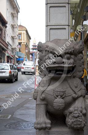 Stone figure of a dragon sits at the entrance to Chinatown, San Francisco, California on Grant Street at Bush.