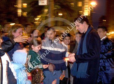 The mayor of San Francisco, Gavin Newsom, works the crowds of people lined up along the streets of Chinatown to watch the Chinese New Year Parade, San Francisco, California.