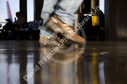 Feet walking at an airport.