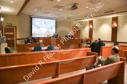 Video arraignment in criminal court in Boise, Idaho. Defendants appear on video screen from secure jail facility while judge in courtroom conducts arraignment and sets bond.