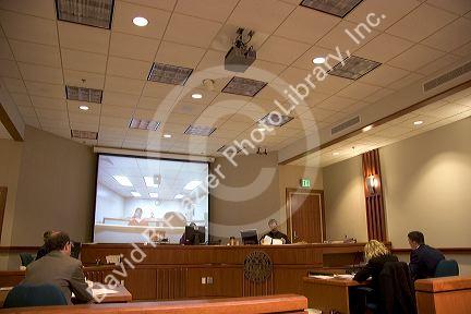 Video arraignment in criminal court in Boise, Idaho. Defendants appear on video screen from secure jail facility while judge in courtroom conducts arraignment and sets bond.