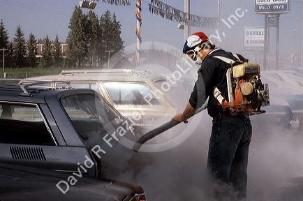 People wearing face masks clean up ash in the aftermath of the Mount St. Helens eruption 1980. Moscow, Idaho.