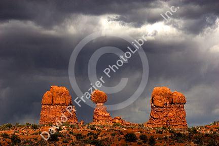 Rock formations at Arches National Park near Moab, Utah against a storm cloud.