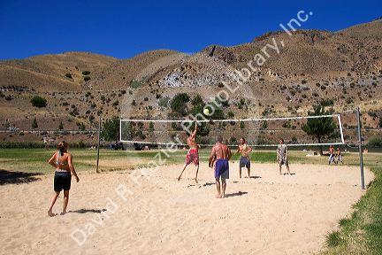Teens playing beach volleyball at Sandy Point near Boise, Idaho.
