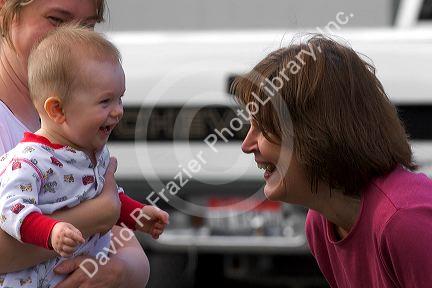 Woman smiling at baby.