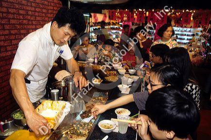 People eating at a night market in Taipei, Taiwan.