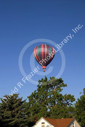Hot air balloon over houses in Boise, Idaho.
