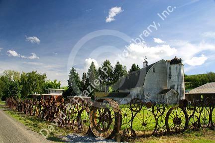 Farm in eastern Washington with old implement wheels fashioned into a fence.
