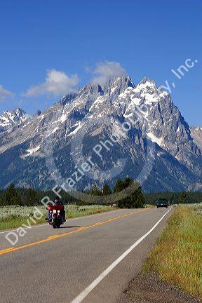 Vehicles travel on the highway through Grand Teton National Park, Wyoming.