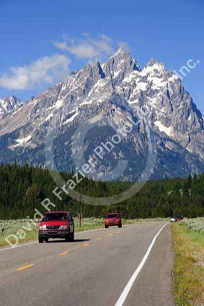 Vehicles travel on the highway through Grand Teton National Park, Wyoming.