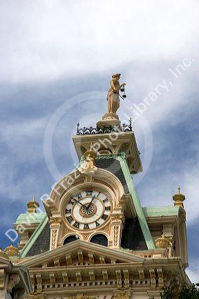 The scales of justice and clock on top of the courthouse in Davis County, Bloomfield, Iowa.