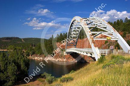 Arched iron suspension bridge along highway 191 at Flaming Gorge National Recreation Area in Utah.