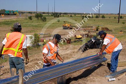 Highway construction crew installing a guardrail on I-80 and I-76 near Big Springs, Nebraska.