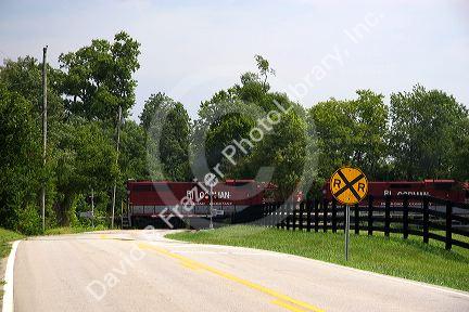 Rural railroad crossing with train near Lexington, Kentucky.