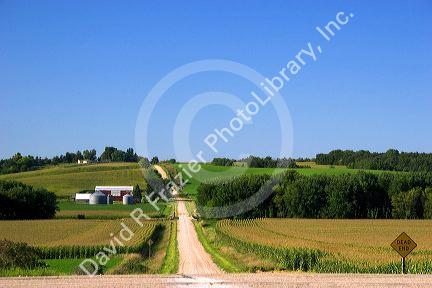 Country road with farm and corn fields, south west of Traer, Iowa.