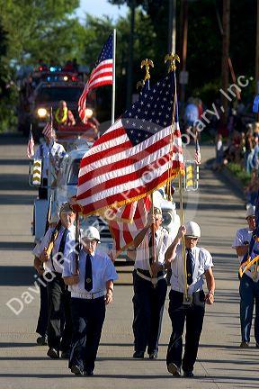 Veterans of Traer, Iowa march as honor guard in a parade for the Festival of the Spiral Steps.