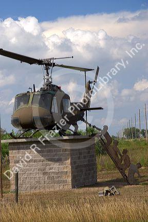 A huey chopper and silhouette of soldiers depicts the 