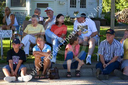 Residents of Traer, Iowa watch a parade for the Festival of the Spiral Steps.