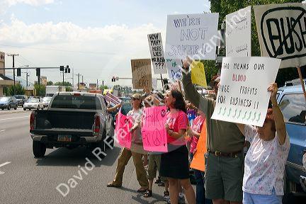 People holding signs at an Anti-war protest in Salt Lake City, Utah. 8/22/2005