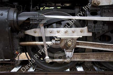 Close up detail view of steam locomotive drive wheel.