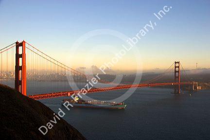 A container ship passes under the Golden Gate Bridge in the San Francisco Bay, California.