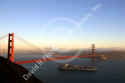 A container ship passes under the Golden Gate Bridge in the San Francisco Bay, California.