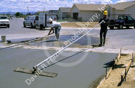 Workers floating a concrete driveway at a subdivision in Idaho.